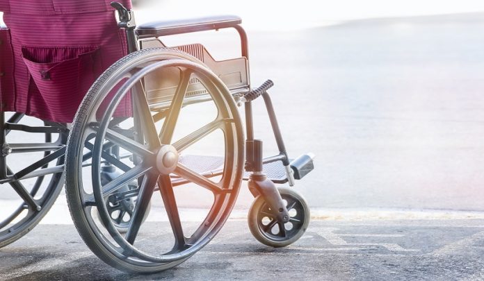 Close,Up,View,Of,Empty,Wheelchair,With,Pavement,Handicap,Symbol Permessi per assistenza ai disabili e congedi straordinari