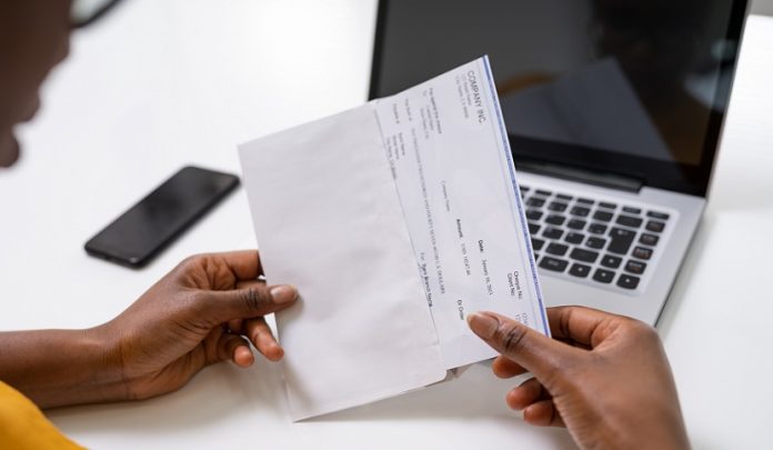 American,African,Holding,Paycheck,Or,Payroll,Check Requisito reddituale nelle controversie di natura assistenziale