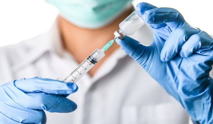 Doctor,,Nurse,,Scientist,Hand,In,Blue,Gloves,Holding,Flu,,Measles, Iniezione intramuscolo provoca infezione e ascesso